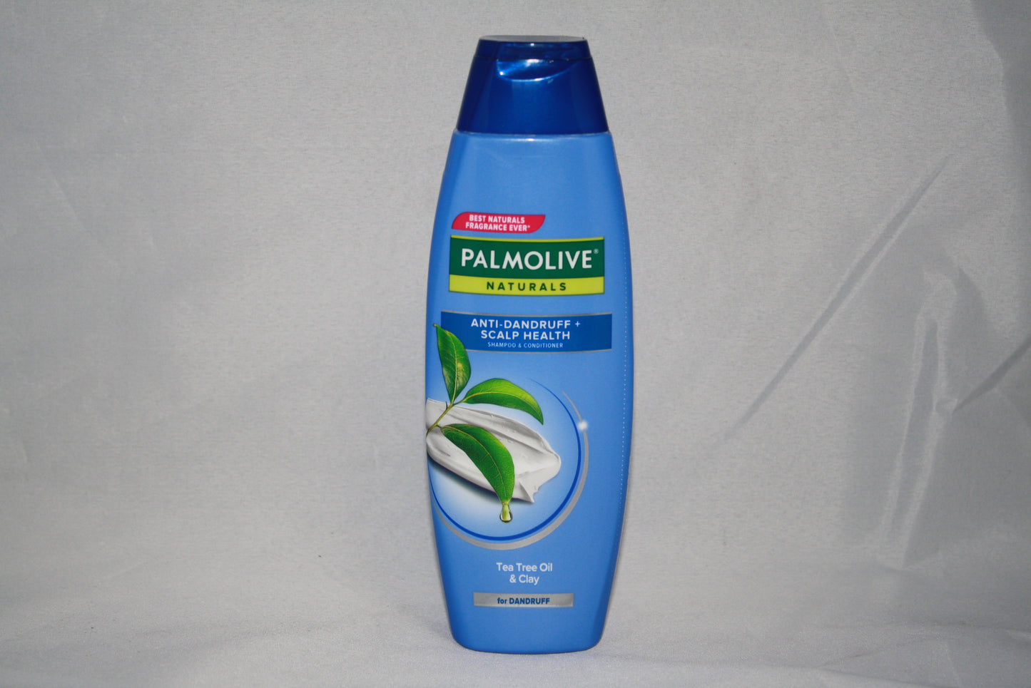 Palmolive shampoo bottle on a gray background